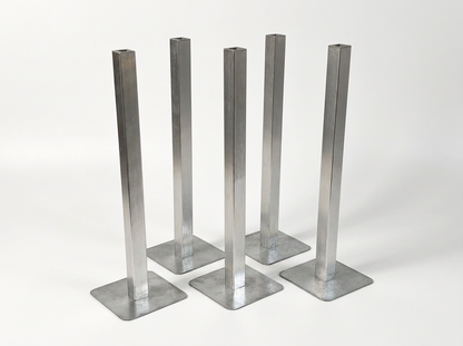 Five galvanized steel pedestal legs with square flat bases, arranged in a row on a light gray studio background.