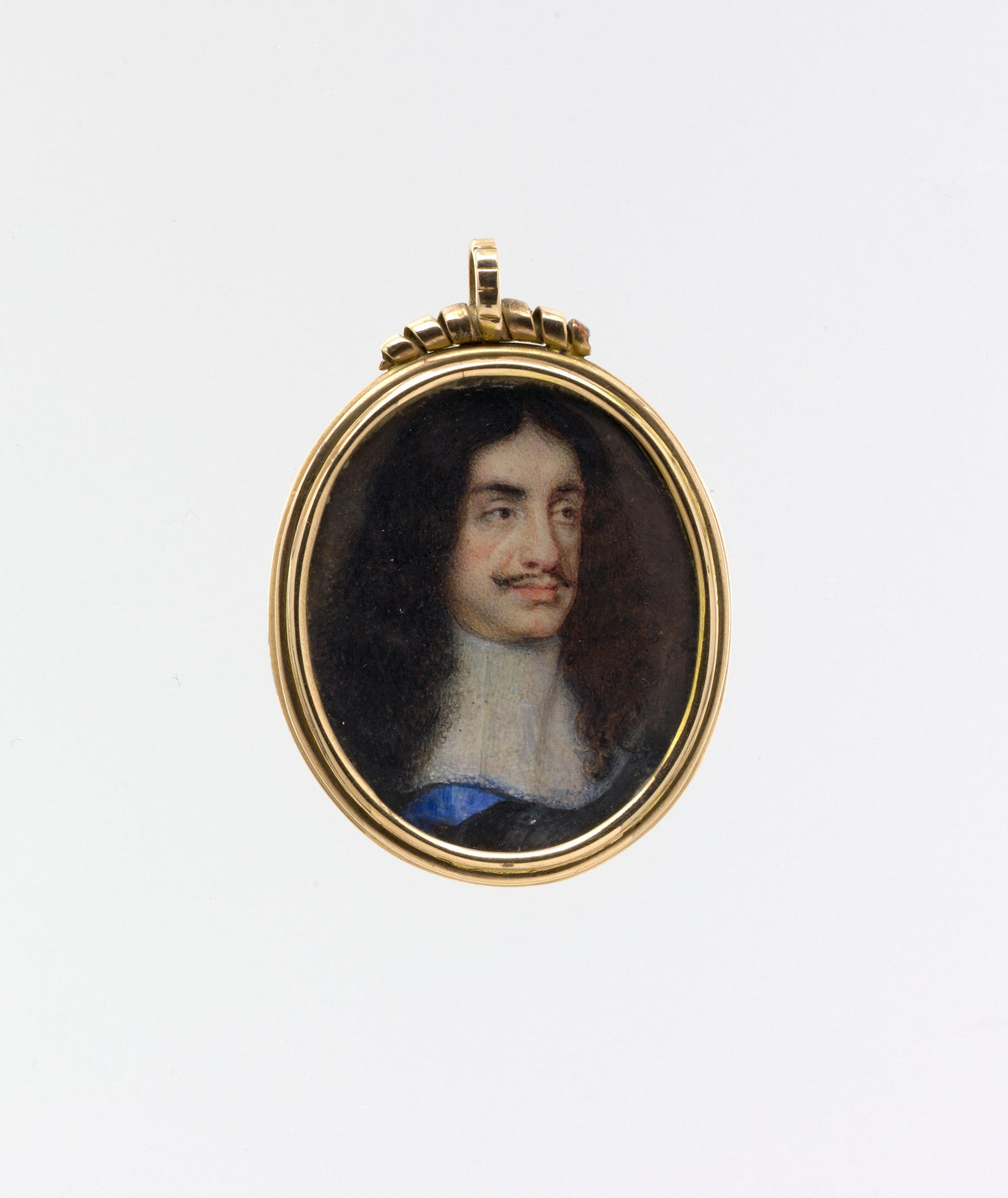 Portrait pendant of a man with dark hair and a white shirt, set in a gold frame on a white background.