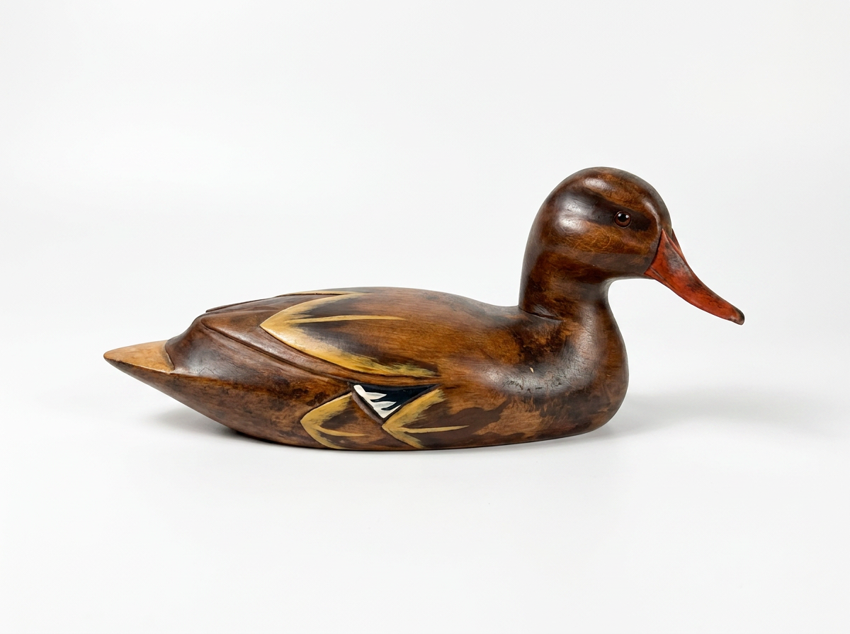 A handcrafted wooden duck deco sculpture, featuring a glossy dark brown finish with gold, black, and white inlay details on its back and wings, and a reddish-orange beak, set against a plain white background.