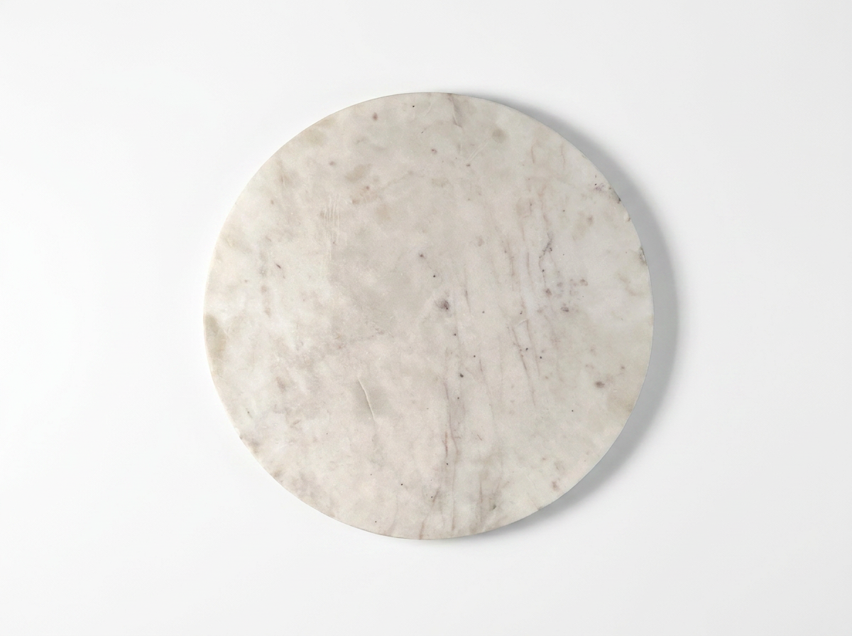 A round white marble board with natural gray and beige veining, photographed from directly above on a clean white background.