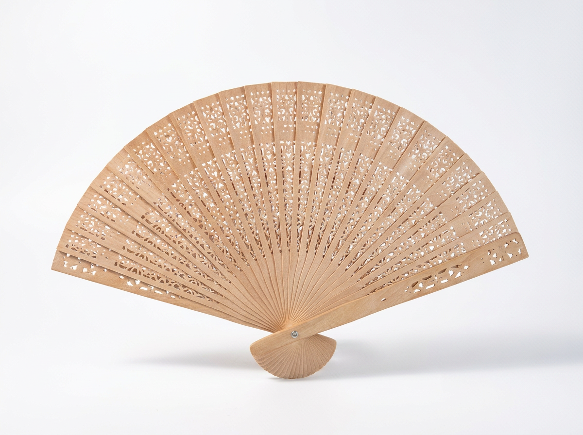 A light natural wood folding hand fan with intricate laser-cut geometric patterns, displayed open on a clean white background.