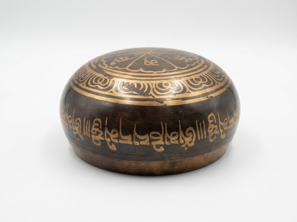A small oval wooden box with a dark brown finish and gold calligraphy, photographed on a light gray background.